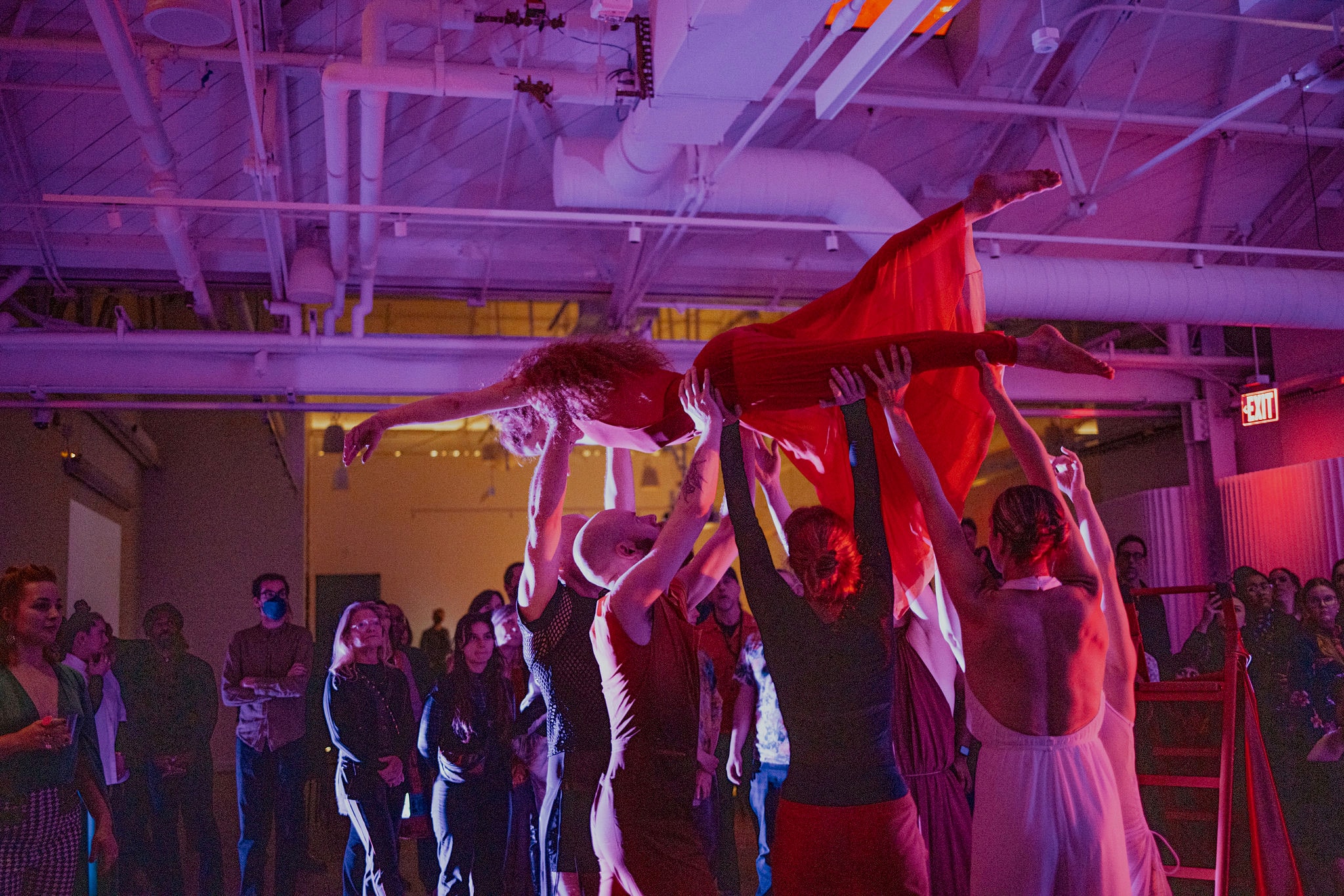 Motion blurred dancers in art gallery loft