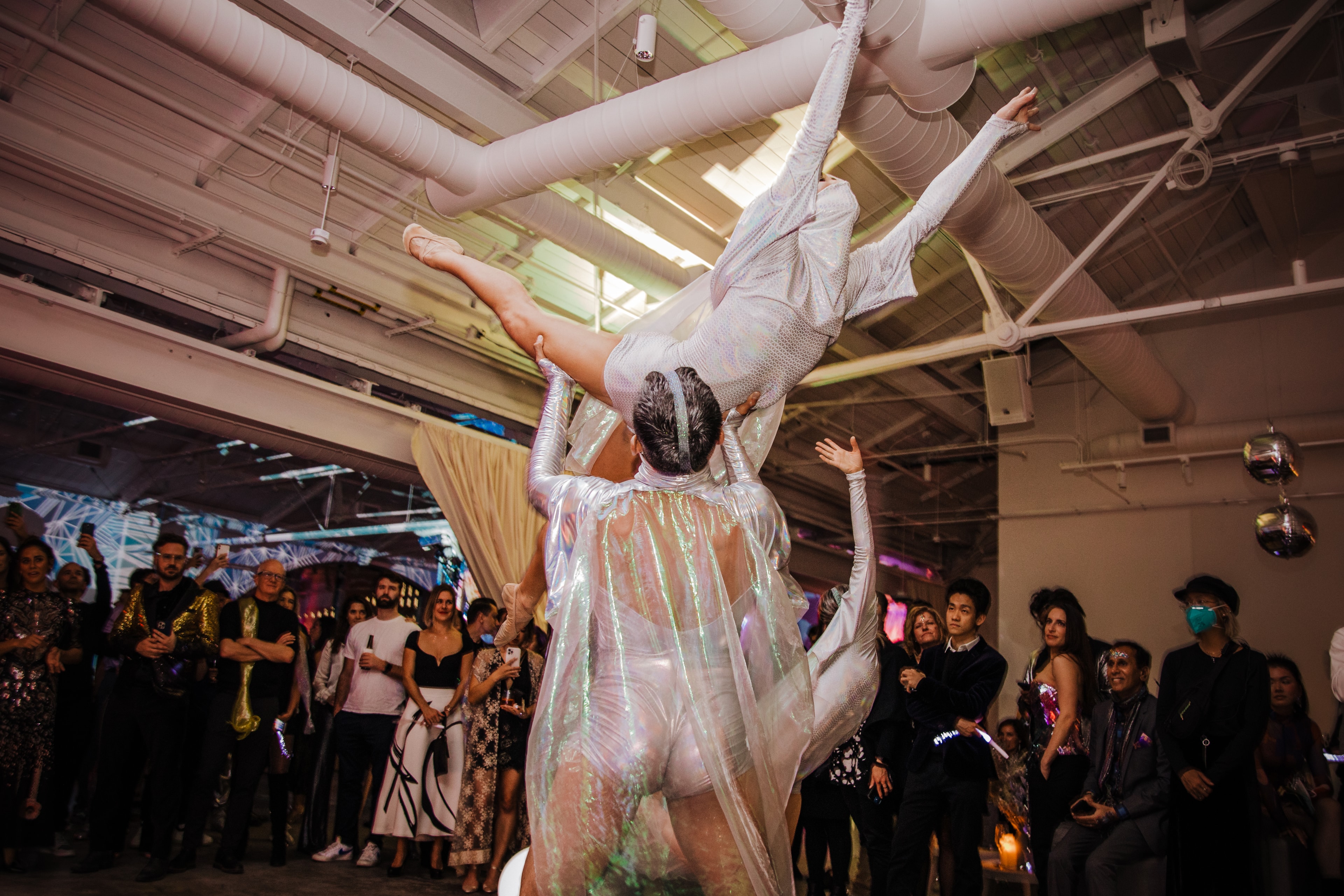 Two women in dynamic movement before mural