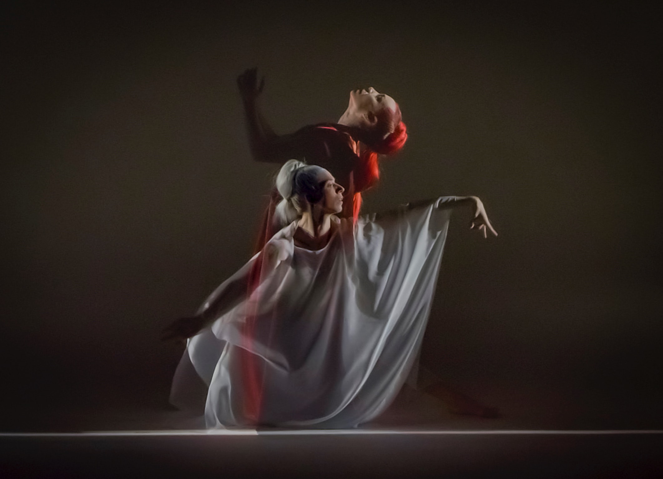 Person reaching toward dramatic cinematic light